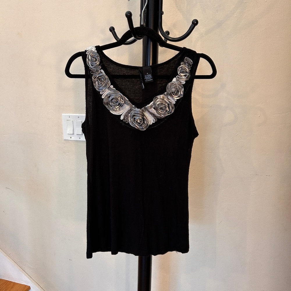 Fitted highly stretchy black tank top with silver roses neckline.